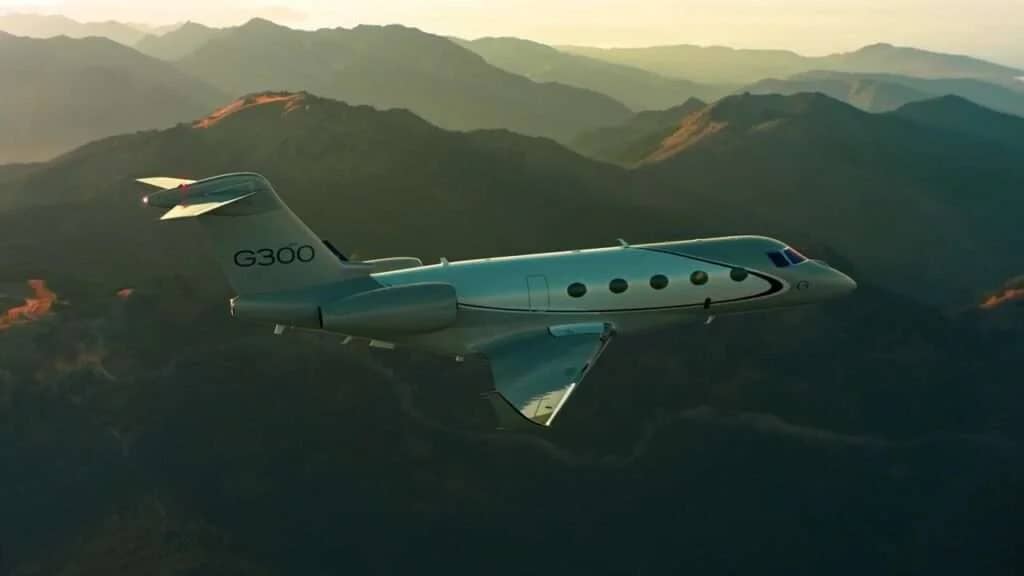 Gulfstream G300 business jet in flight over mountains